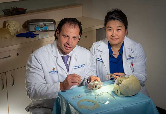 Dr. Gordon and Dr. Huang examining reconstruction implants