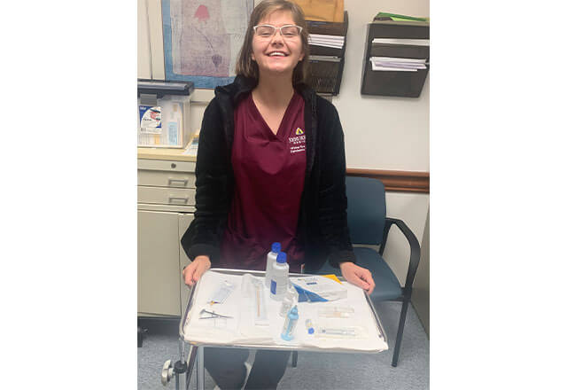 Breanna Soldatelli with a sterile tray of instruments