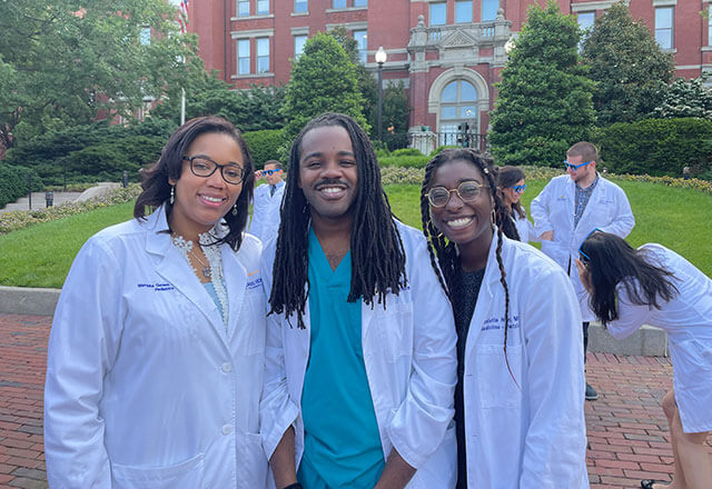 Marquita Genies, left, at the end-of-year celebration for the Harriet Lane Pediatric Residency Program with Thomas Elliott and Christle Nwora