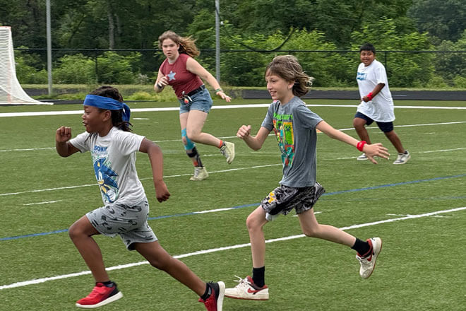 kids running and playing soccer
