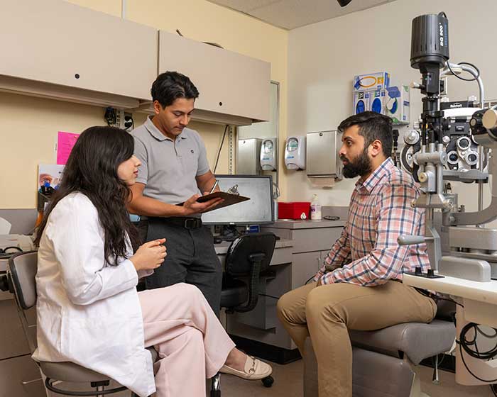 Two doctors speaking with a patient