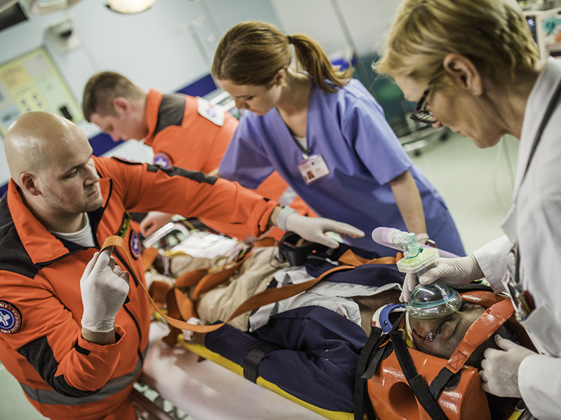 EMTs pushing patient on a stretcher