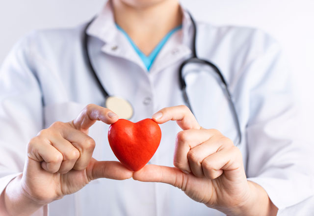 Doctor holding red heart shape