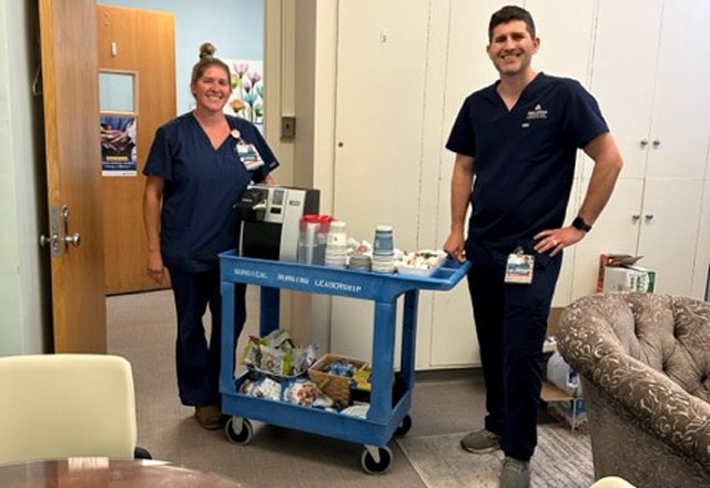 Nurses at Johns Hopkins Hospital stand with their rolling wellness cart