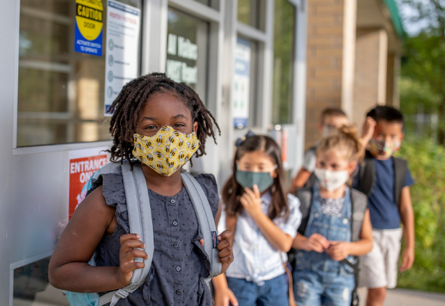 kids in line at school wearing face masks