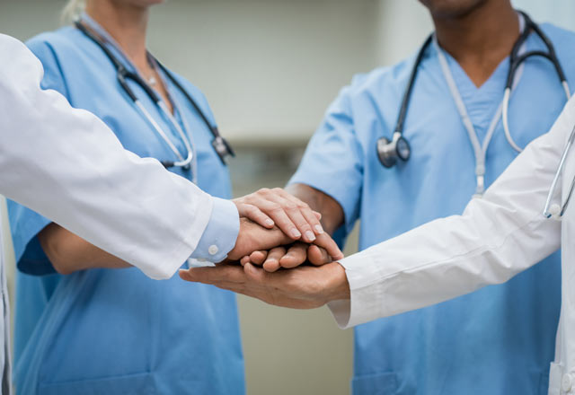 Medical team putting their hands together