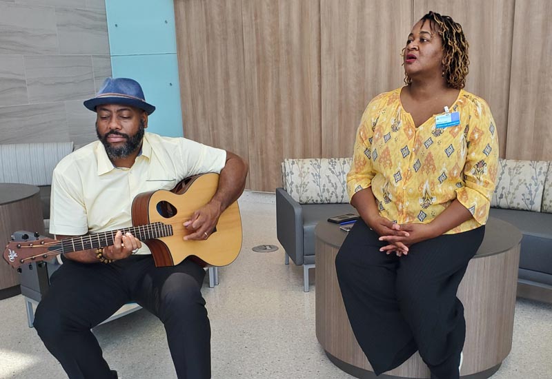Musicians playing music and singing at Suburban Hospital