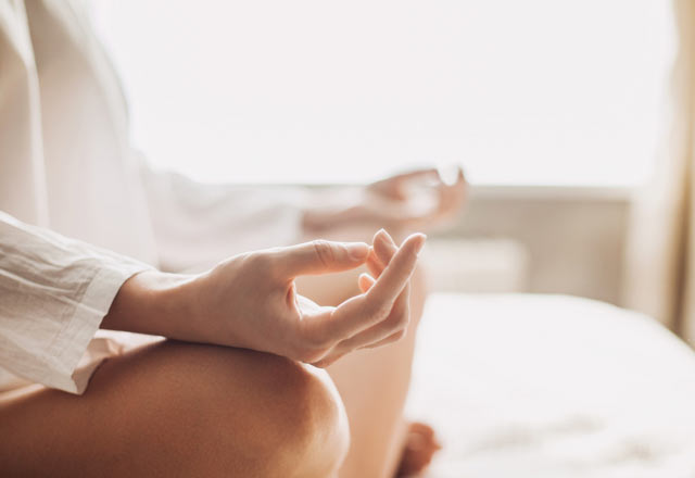 Woman practicing meditation in a calming room