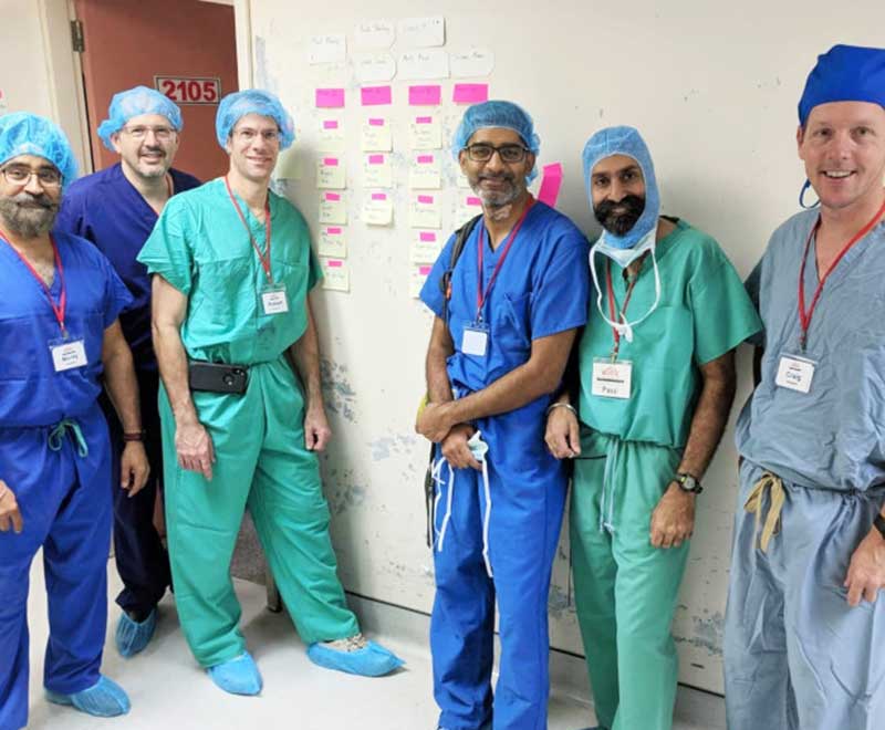 Dr. Khanuja and team in scrubs