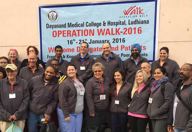 The Operation Walk Maryland group standing together for a photographic in front banner announcing the event.