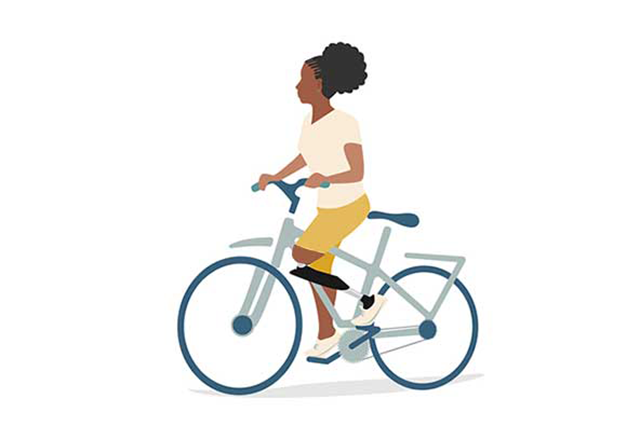 Lady riding a bike with an OI leg prosthetic