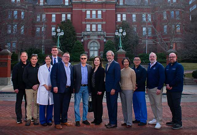 Osseointegration care team posing in front of the Johns Hopkins dome.