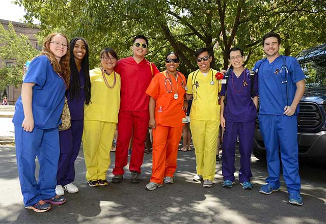 Healthcare workers wearing colored scrubs for pride.