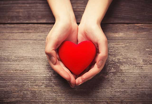 woman holding red heart