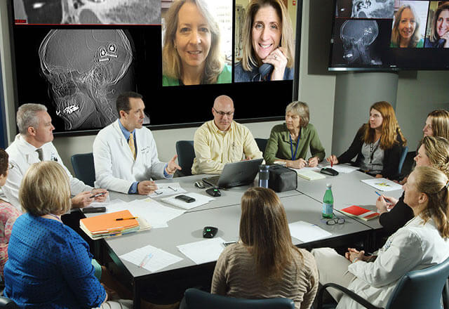Johns Hopkins Cochlear Implant Specialists in a conference room