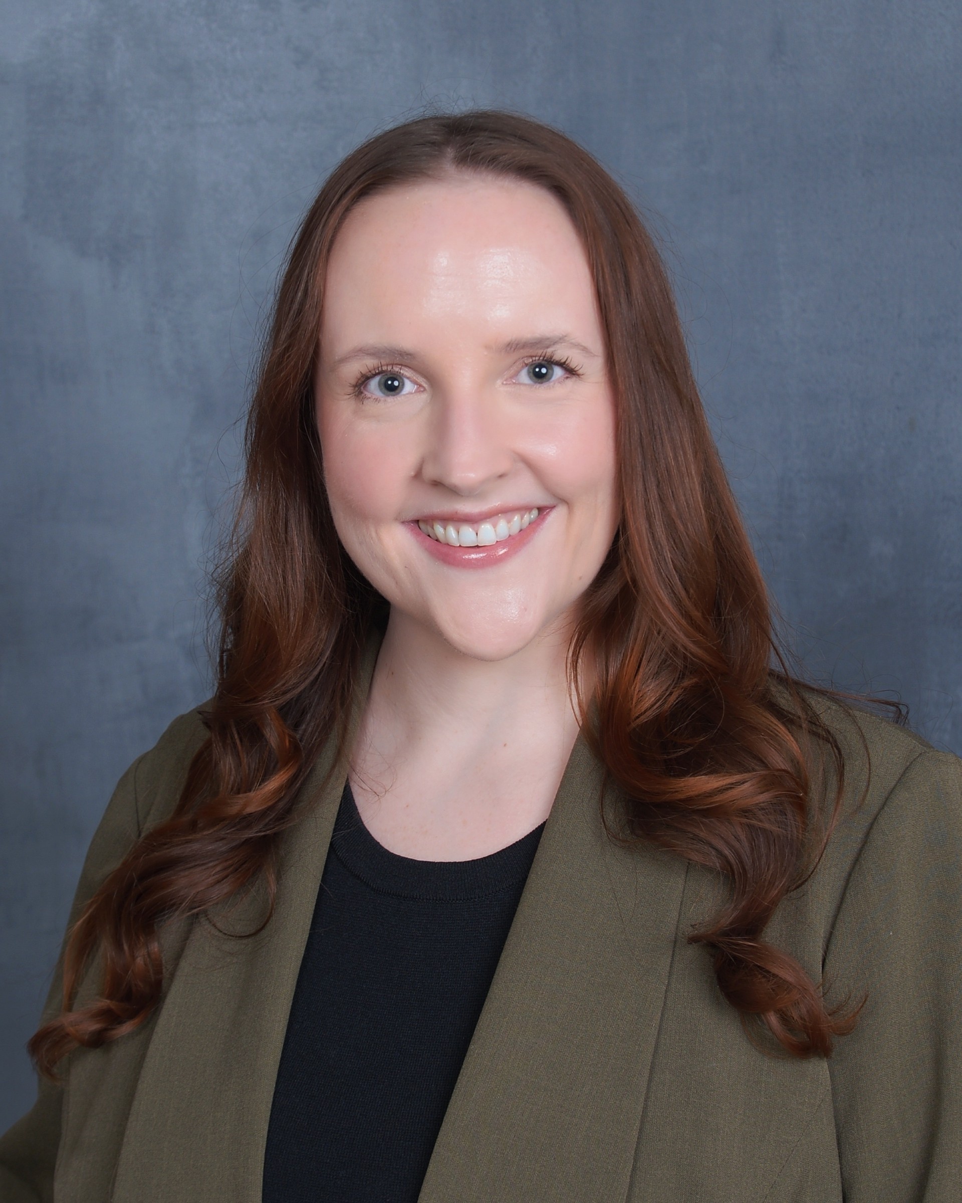 Sylvia Lane smiles for a professional headshot.