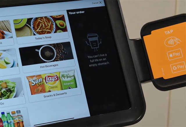 A Grubhub payment kiosk showing the food menu and a payment terminal