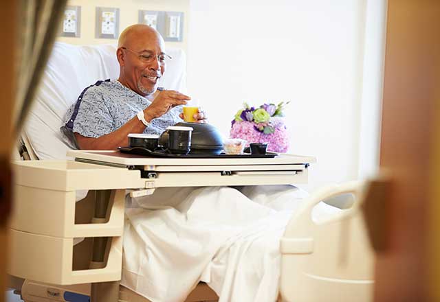 Patient eating in hospital bed