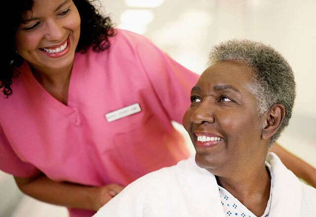 nurse smiling with elderly patient