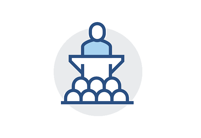 Icon of a speaker at a conference in front of a crowd.