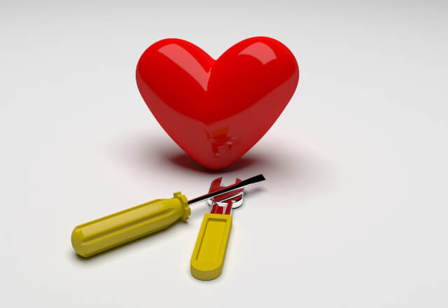 a heart with a wrench and screwdriver
