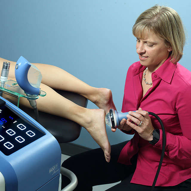 Therapist using compression therapy on a patient's foot.