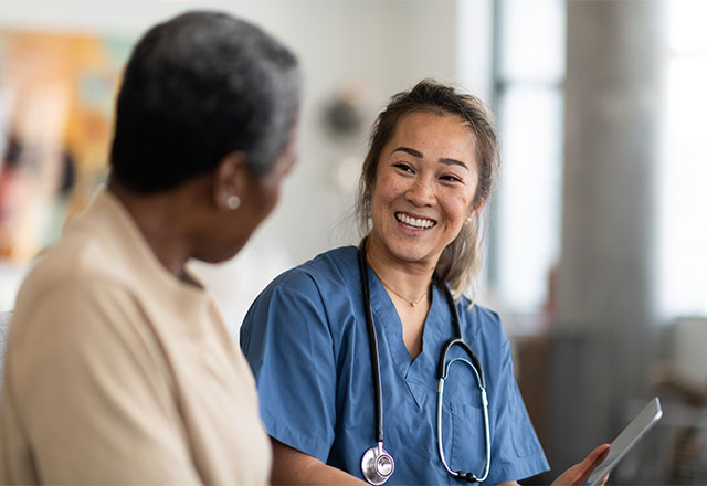 A nurse talking to a patient.