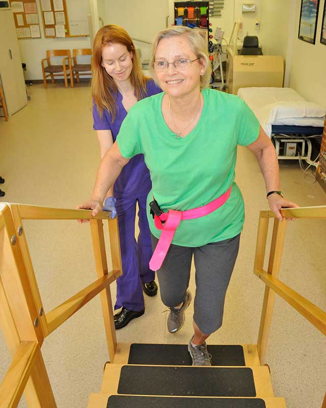 Nurse working with patient on walking platform