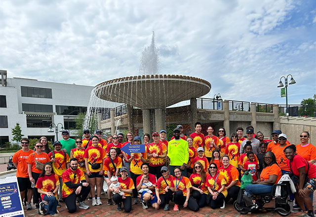 Walk-n-Roll-a-thon participants and supports gather in front of a fountain.