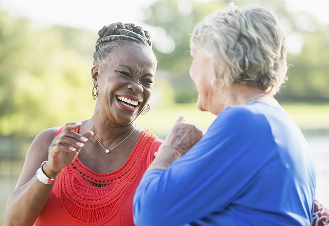 two older women talk and laugh