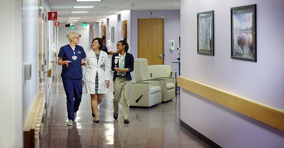 Staff walk down the Meyer hallway.