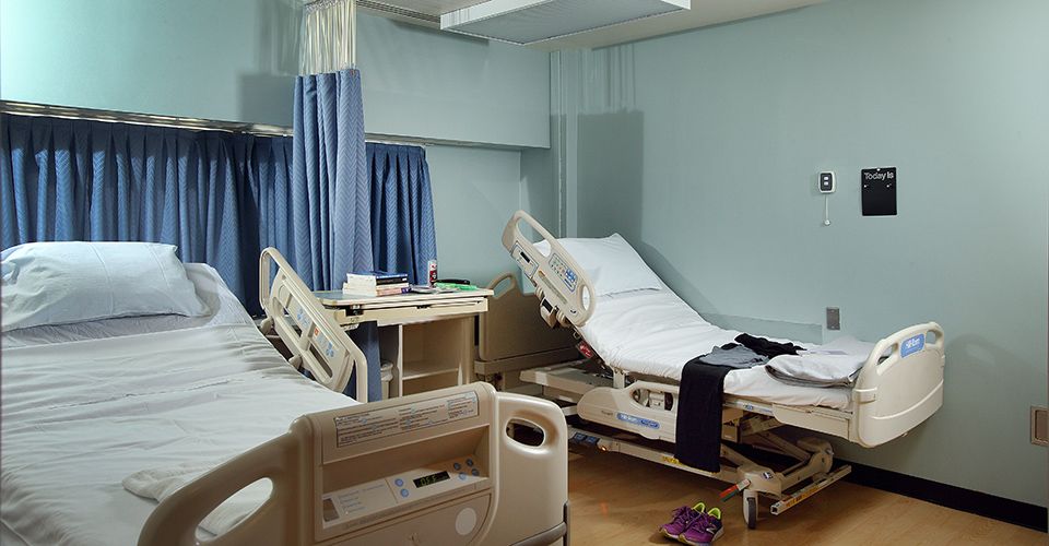 Two hospital beds in a patient room.