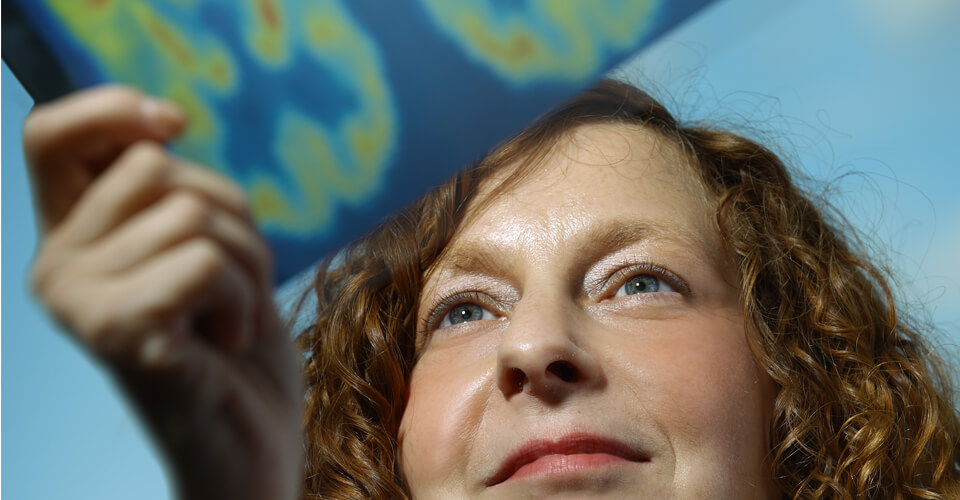 Gwenn Smith, Ph.D. with brain imaging