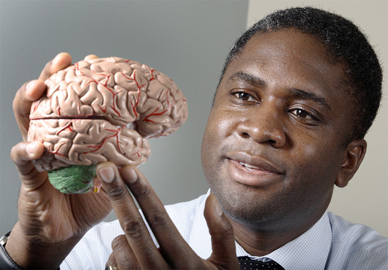 Dr Chiadi Onyike with brain model