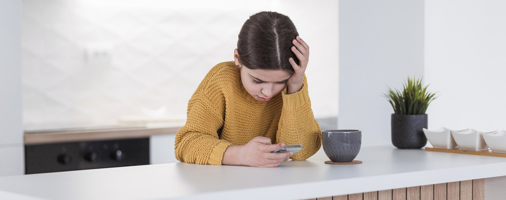 A young girl looking at a phone
