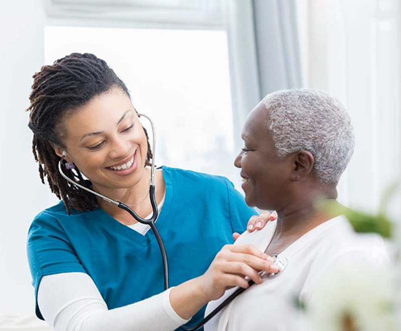 a nurse checks a patient's vital signs