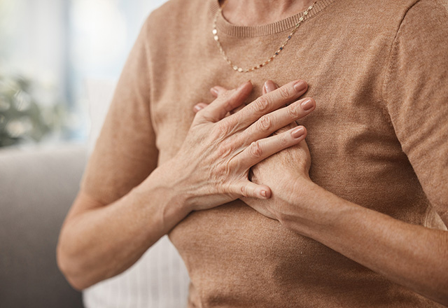 A woman clutching her chest.