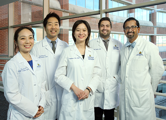 Physicians standing while smiling