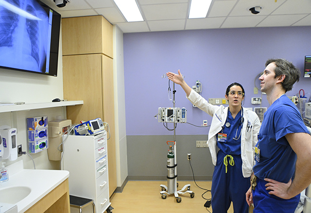 medical student and professor in the sim lab