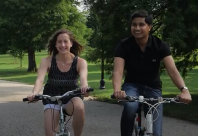 two people riding a bike through patterson park in baltimore