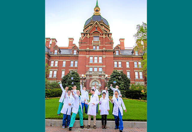 residents in front of Hopkins building