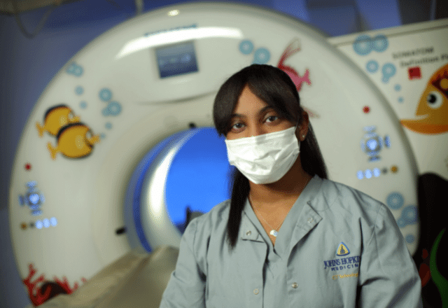 Doronella Simon in front of MRI machine