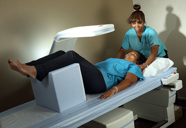 Doctor talking to older female patient about DEXA scan