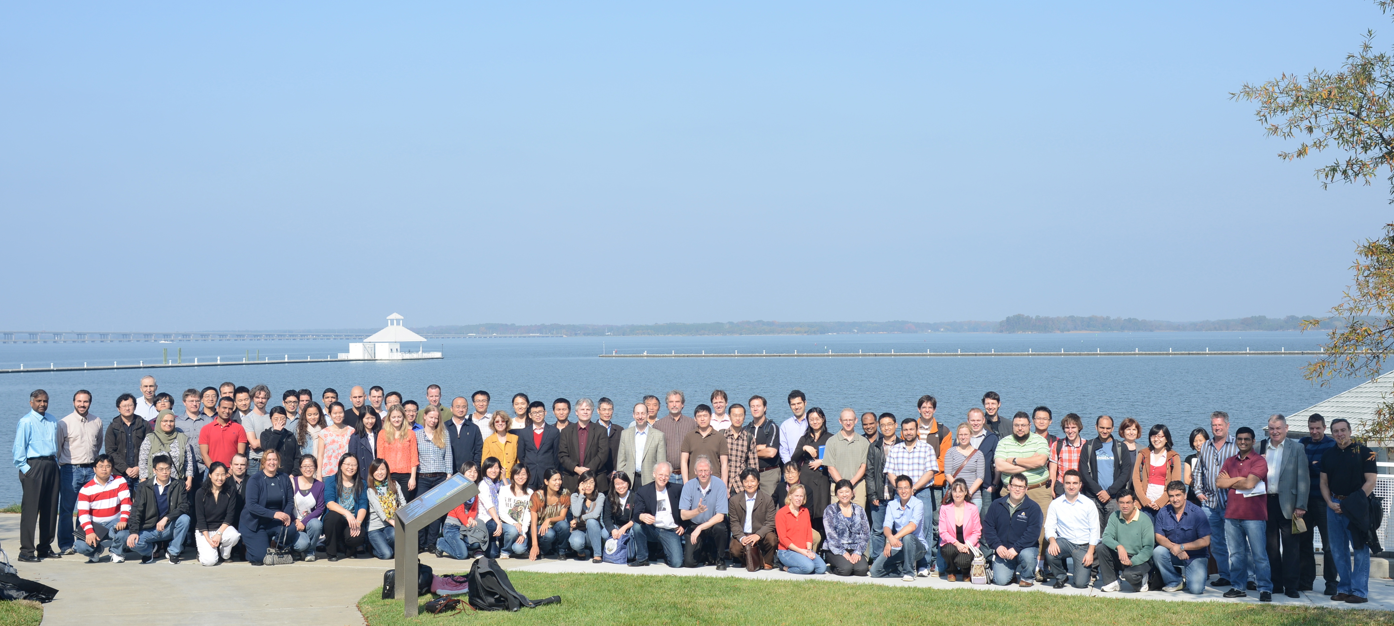radiology group poses in front of water at harbor