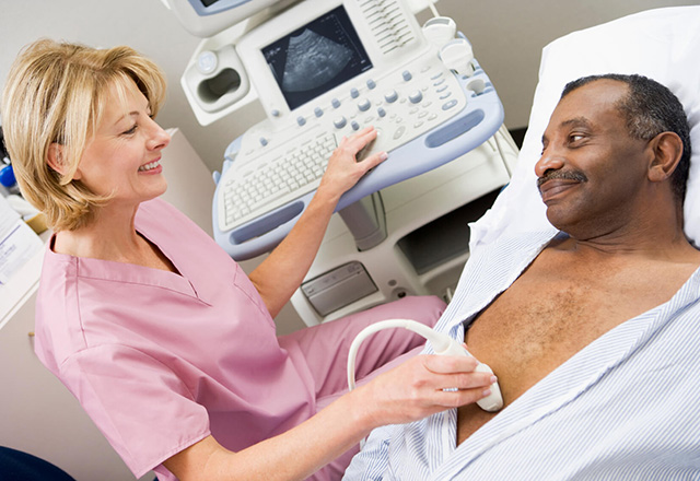 Radiology technologist preparing patient for ultrasound
