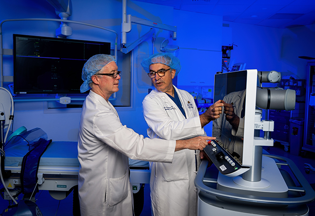 Robert Liddell and Christos Georgiades in an IR Suite demonstrating the histotripsy equipment