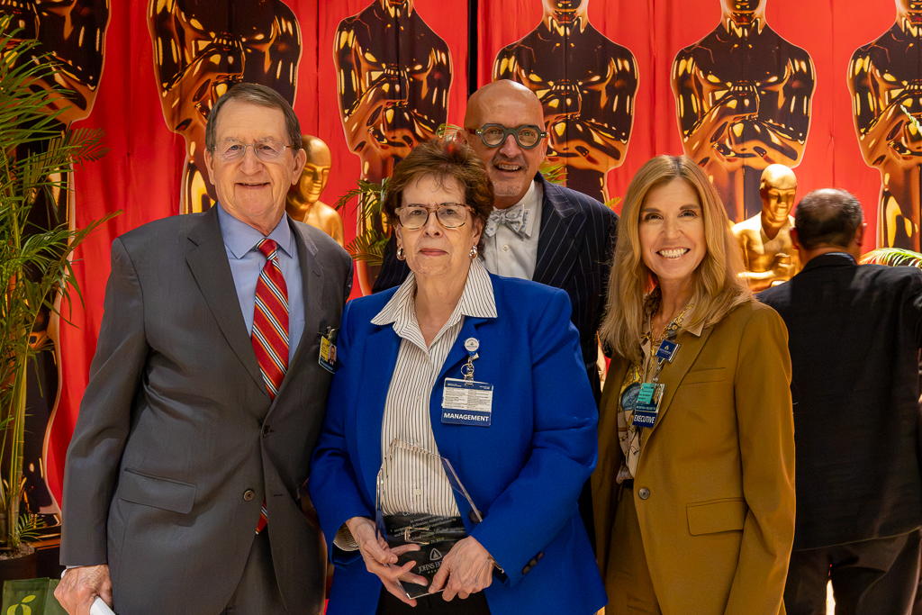 Honoree (center) Peg Cooper with (from left) Ronald R. Peterson, Kevin Sowers and Dr. Redonda Miller