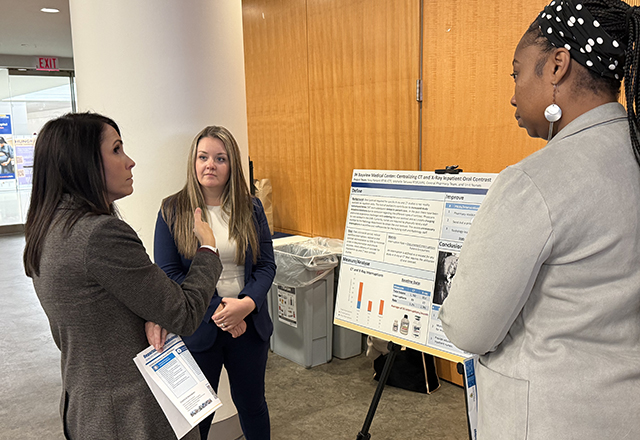 Faculty looking at posters