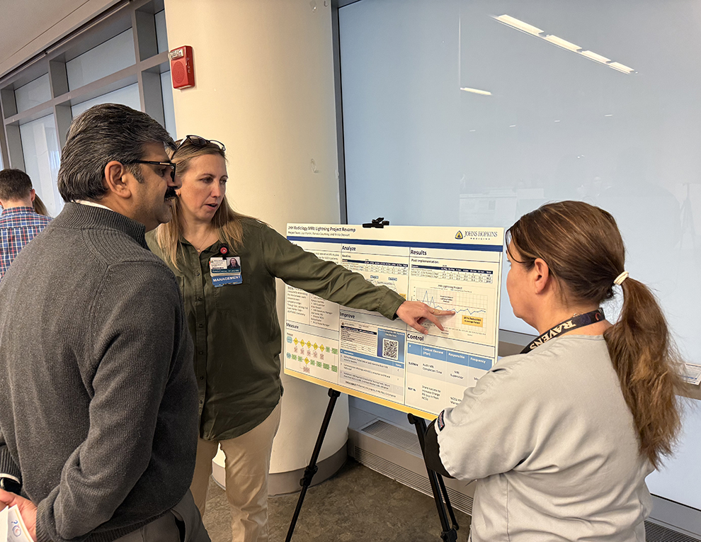 Faculty looking at posters