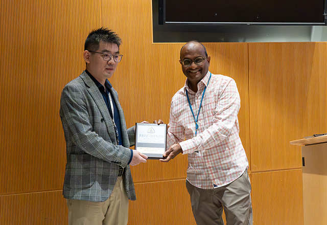 Dr. Sridhar Nimmagadda (right) presented a research award to Dr. Zhiliang Wei.